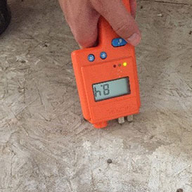 Using moisture meter to check moisture in concrete